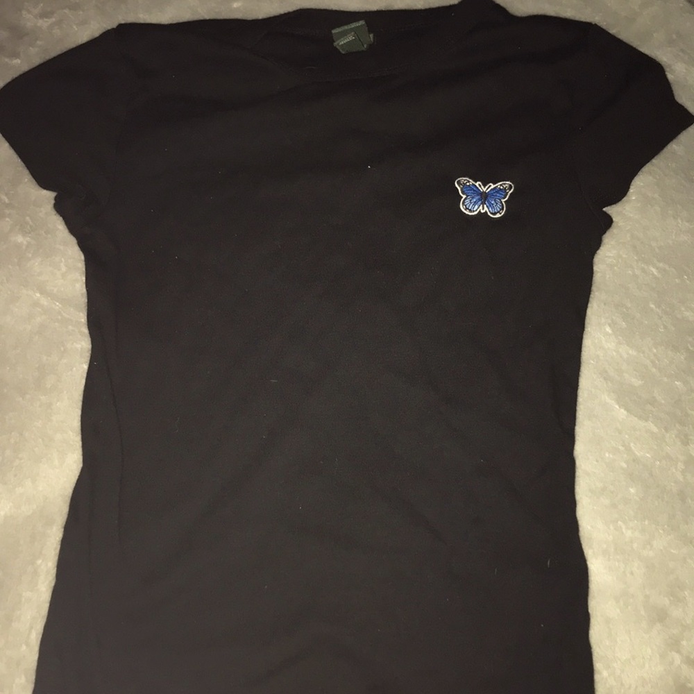 Tight shirt with blue butterfly on it